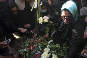 Iranians put flowers onto the grave of Neda Agha-Soltan as mourners gather at Tehran's Behesht-e Zahra cemetery July 30, 2009. Baton-wielding Iranian police fired tear gas on Thursday and arrested protesters mourning the young woman killed in post-election violence who has become a symbol for the opposition to Tehran's hardline leaders.  REUTERS/Reuters via Your View (IRAN CONFLICT POLITICS IMAGES OF THE DAY)