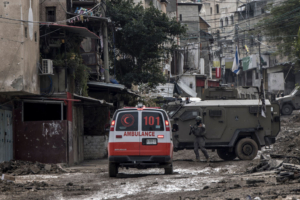 TOPSHOT - CORRECTION / An Israeli soldier gestures towards a Palestinian Red Crescent ambulance at the entrance of the Tulkarem refugee camp in Tulkarem, in the occupied West Bank, on January 17, 2024 during a military operation. (Photo by MARCO LONGARI / AFP) / "The erroneous mention appearing in the metadata of this photo by MARCO LONGARI has been modified in AFP systems in the following manner: [Red Crescent ambulance] instead of [Red Cross ambulance]. Please immediately remove the erroneous mention from all your online services and delete it from your servers. If you have been authorized by AFP to distribute it to third parties, please ensure that the same actions are carried out by them. Failure to promptly comply with these instructions will entail liability on your part for any continued or post notification usage. Therefore we thank you very much for all your attention and prompt action. We are sorry for the inconvenience this notification may cause and remain at your disposal for any further information you may require." (Photo by MARCO LONGARI/AFP via Getty Images)