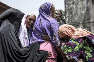 Family and community members mourn the death of Kudidiabou Bah in Conakry on March 01, 2020. - Kudidiabou, who was pregnant, allegedly succumbed internal bleeding caused after an altercation with security forces during a protest on February 29, 2020. Guinea's opposition on February 29, 2020 called for the cancellation of a referendum on changing the constitution, as fresh protests against President Alpha Conde's government broke out in the capital Conakry. The referendum will decide whether to adopt a new constitution, which includes bans on female circumcision and underage marriage in the West African country. (Photo by JOHN WESSELS / AFP)