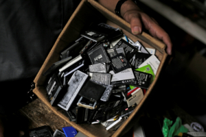 A man shows batteries from discarded cell phones in a box in his stall at the Oriental Market in Managua, Nicaragua October 23, 2018. REUTERS/Jorge Cabrera