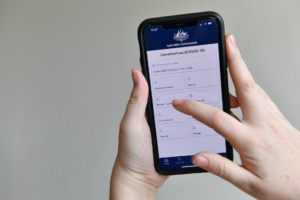 A person is seen using the Australian government coronavirus (COVID-19) app on an iPhone in Brisbane, Saturday, April 18, 2020. Prime Minister Scott Morrison has ruled out forcing Australians to download a coronavirus tracing app which would use data from people's phones to inform health authorities of close contacts of confirmed COVID-19 cases.  (AAP Image/Darren England) NO ARCHIVINGNo Use Australia. No Use New Zealand.