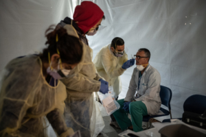 NEW YORK, NY - MARCH 24: Doctors test hospital staff with flu-like symptoms for coronavirus (COVID-19) in set-up tents to triage possible COVID-19 patients outside before they enter the main Emergency department area at St. Barnabas hospital in the Bronx on March 24, 2020 in New York City. New York City has about a third of the nationâ€™s confirmed coronavirus cases, making it the center of the outbreak in the United States.