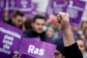 A protester raises a clenched fist during a demonstration to protest femicide and violence against women in Paris, France, November 23, 2019. REUTERS/Christian Hartmann