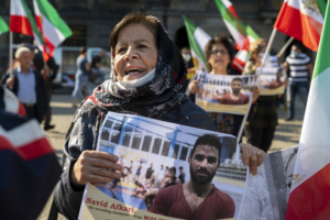 A woman holds a portrait of Iranian wrestler Navid Afkari during a demonstration on the Dam Square in Amsterdam, the Netherlands, on September 13, 2020, against its execution in the southern Iranian city of Shiraz and against the Iranian government. Iran said it executed wrestler Navid Afkari, 27, on September 12, 2020 at a prison in the southern city of Shiraz over the murder of a public sector worker during anti-government protests in August 2018. Reports published abroad say Afkari was condemned on the basis of confessions