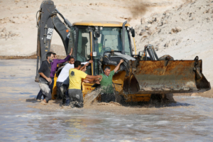 Activists try to block an Israeli machinery in the Palestinian Bedouin village of Khan al-Ahmar that Israel plans to demolish, in the occupied West Bank