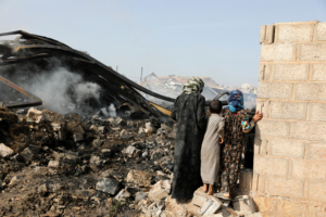 Children look at wreckage of a vehicle oil and tires store hit by Saudi-led air strikes in Sanaa, Yemen July 2, 2020. REUTERS/Khaled Abdullah