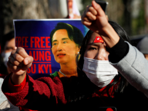 FILE PHOTO: Protesters from Myanmar residing in Japan raise their fists and hold a poster depicting Aung San Suu Kyi during a rally against Myanmar's military, after it seized power from a democratically elected civilian government and arrested Suu Kyi, outside Foreign Ministry in Tokyo, Japan February 3, 2021. REUTERS/Issei Kato/File Photo