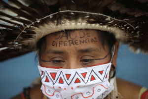 Indigenous midwife Moy from Satere Mawe ethnicity, attends a protest demanding the entrance of traditional healers and better medical care at the Hospital Nilton Lins, which inaugurated a exclusive area for indigenous people to be treated from the coronavirus disease (COVID-19) in Manaus, Brazil June 3, 2020. The message on her forehead reads "Differentiated Health". Picture taken June 3, 2020. REUTERS/Bruno Kelly