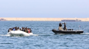 Un bateau des garde-côtes libyennes escorte un bateau de migrants
