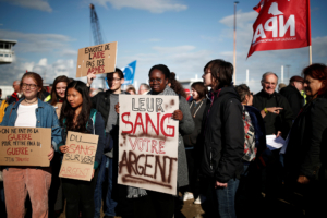 People attend a demonstration to protest against the loading of weapons aboard the Bahri-Yanbu, a cargo ship operating for Saudi Arabia's defence and interior ministries, in Le Havre, France, May 9, 2019. The banner reads: "Their blood, your money".