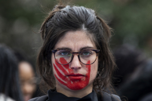 MADRID, SPAIN - MARCH 08: A woman wears red face paint depicting a hand during a protest during the International Women's Day on March 08, 2020 in Madrid, Spain. Spain celebrates International Women's Day today with countless protests scheduled throughout the day across the country in defense of their rights. Some of feminist movement's demands are equal working rights, women's right to abortion and an end to violence against women, to racism and to xenophobia across the globe. (Photo by Pablo Blazquez Dominguez/Getty Images)