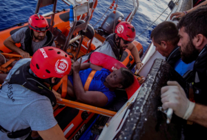 NBA Memphis player Marc Gasol and members of NGO Proactiva Open Arms rescue boat carry Josepha from Cameroon in central Mediterranean Sea, July 17, 2018. Josepha was brought aboard in a state of deep shock and treated by doctors. She told the doctors she had spent the previous night clinging to the wreckage, singing hymns and calling on God for deliverance.