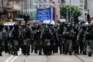 Riot police officers walk as anti-national security law protesters march during the anniversary of Hong Kong's handover to China from Britain, in Hong Kong, China July 1, 2020. REUTERS/Tyrone Siu  REFILE - CORRECTING YEAR