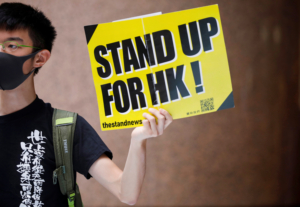 An anti-government protester holding a banner attends a lunchtime protest in Hong Kong, China January 6, 2020. REUTERS/Navesh Chitrakar