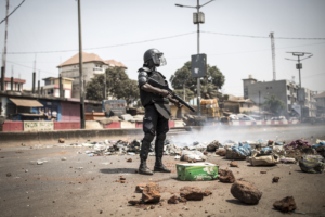 A policeman stands along the "axis of democracy" as protests broke out in Conakry on February 29, 2020. - Guinea's President Alpha Conde announced on February 28, 2020 a "slight postponement" of March 1's referendum on whether to adopt a new constitution, following mounting international criticism over the poll's fairness. (Photo by JOHN WESSELS / AFP)