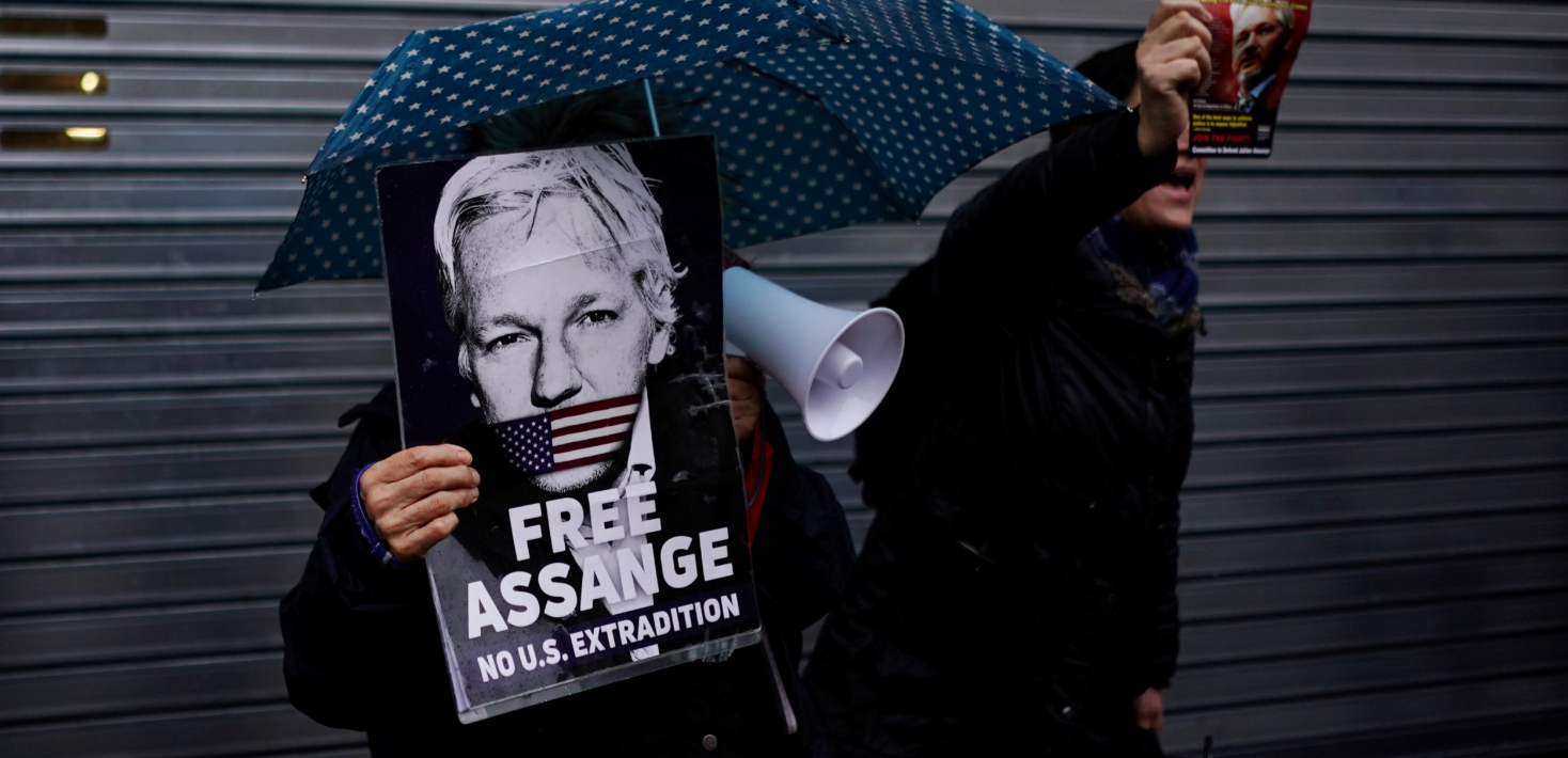 Demonstrators hold placards ahead of WikiLeaks founder Julian Assange appearing before the Spanish High Court via videolink, in London, Britain, December 20, 2019. REUTERS/Henry Nicholls