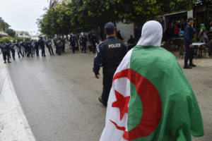 Algerian riot police gather during an anti-government demonstration in the capital Algiers on March 14, 2020. (Photo by RYAD KRAMDI / AFP)