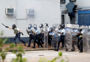 olice officers run as anti-extradition bill protesters demonstrate in Sham Shui Po neighbourhood in Hong Kong, China, August 11, 2019.