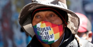 A man with a face mask reading " Bolivia does not shut up" attends a rally demanding Bolivia's President Jeanine Anez's (not pictured) resignation, while the Bolivian Union Workers (COB) declare a pause to protests according to local media, amid the coronavirus disease (COVID-19), in El Alto, on the outskirts of La Paz, August 14, 2020. REUTERS/David Mercado