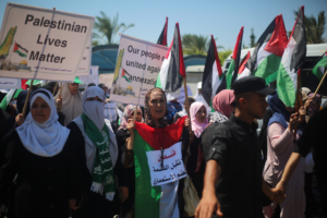 People carrying anti-annexation banners and Palestinian flags gather to stage a protest against Jewish settlements and Israel's annexation plan of Jordan Valley, located in the occupied West Bank on July 01, 2020, in Gaza City, Gaza.