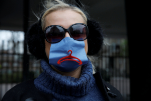 An activist, wearing a protective mask amid the coronavirus disease (COVID-19) outbreak, protests against an initiative to tighten the nation's abortion rules in front of the Parliament in Warsaw, Poland April 15, 2020.