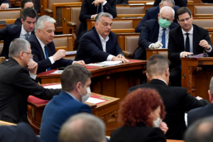 Hungarian Prime Minister Viktor Orban (C) votes with other representatives about the government's bill on the protection against the new coronavirus COVID-19 at the plenary session of the Hungarian Parliament in Budapest, Hungary on March 30, 2020.