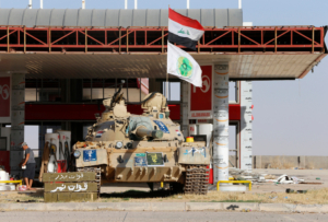 A tank belonging to the Shi'ite Badr Brigade militia takes position in front of a gas station in Suleiman Beg, northern Iraq September 9, 2014. REUTERS/Ahmed Jadallah (IRAQ - Tags: CIVIL UNREST CONFLICT) - RTR45KQ9