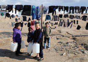 Children hold onto water containers in alHol camp Syria January 8 2020  REUTERS Goran Tomasevic